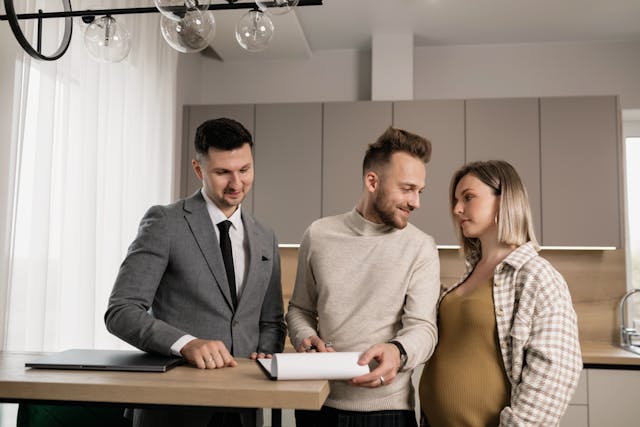 a%20property%20manager%20going%20over%20a%20lease%20with%20two%20tenants a%20property%20manager%20going%20over%20a%20lease%20with%20two%20tenants